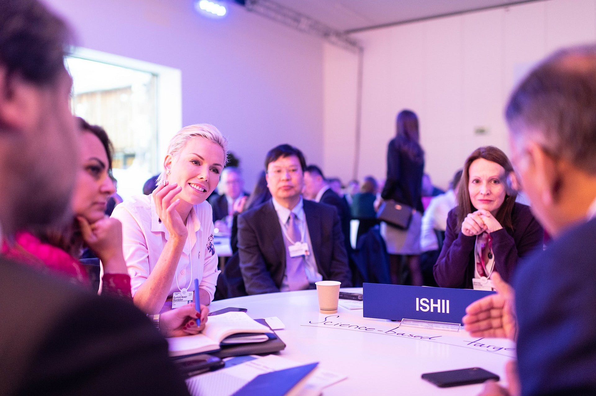 Business audience taking part in a discussion