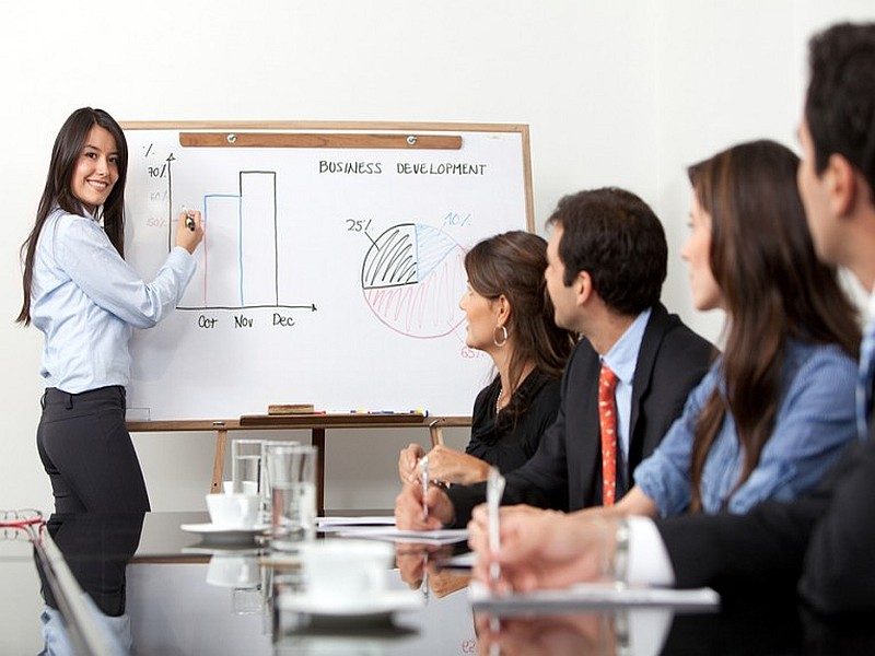 Pretty woman giving an English business presentation